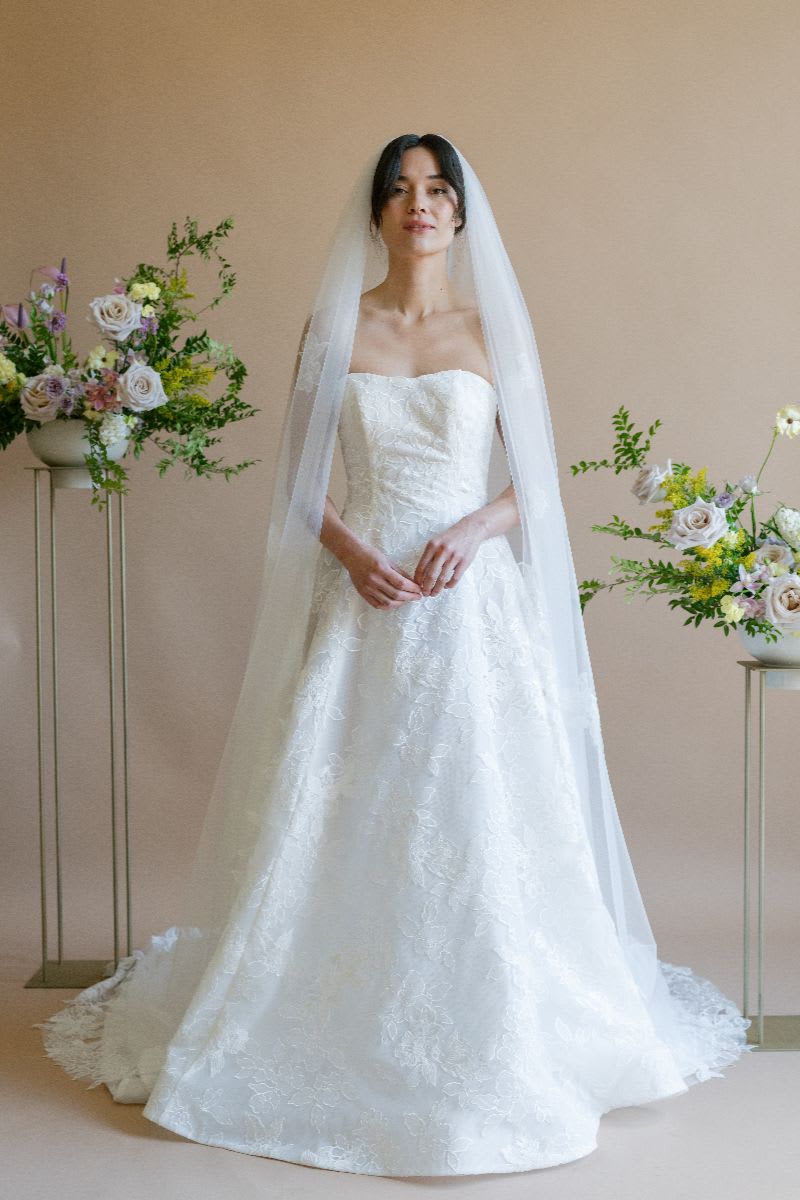 Bride wearing long lace veil 