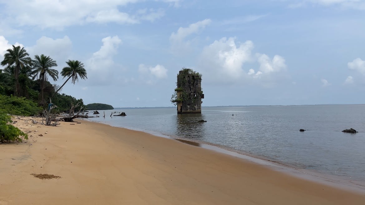 he ghostly concrete ruins of a colonial German maritime prison sit swallowed by the Atlantic tides, a silent, haunting monument to captive history amidst the vast mangrove waters.