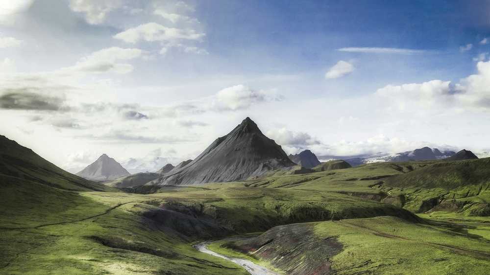Green Highland landscape in Iceland with mountains, valleys, and a winding river