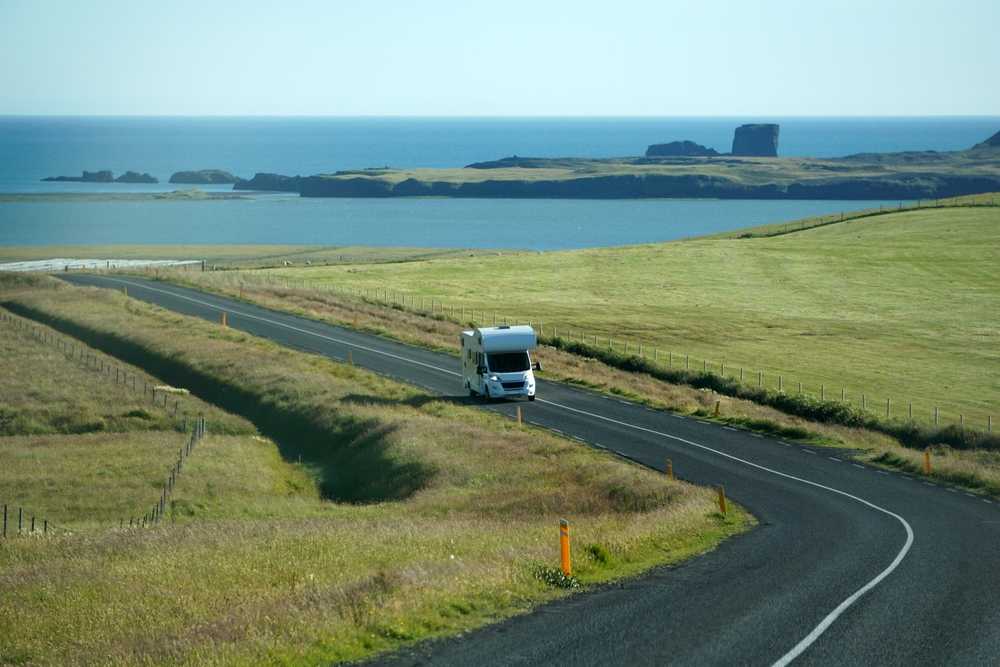 Motorhome driving along a coastal road in Iceland during shoulder season