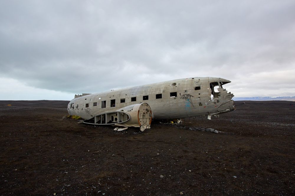 Sólheimasandur plane wreck on Iceland’s black sand desert, abandoned DC-3 fuselage under cloudy sky near the volcanic south coast