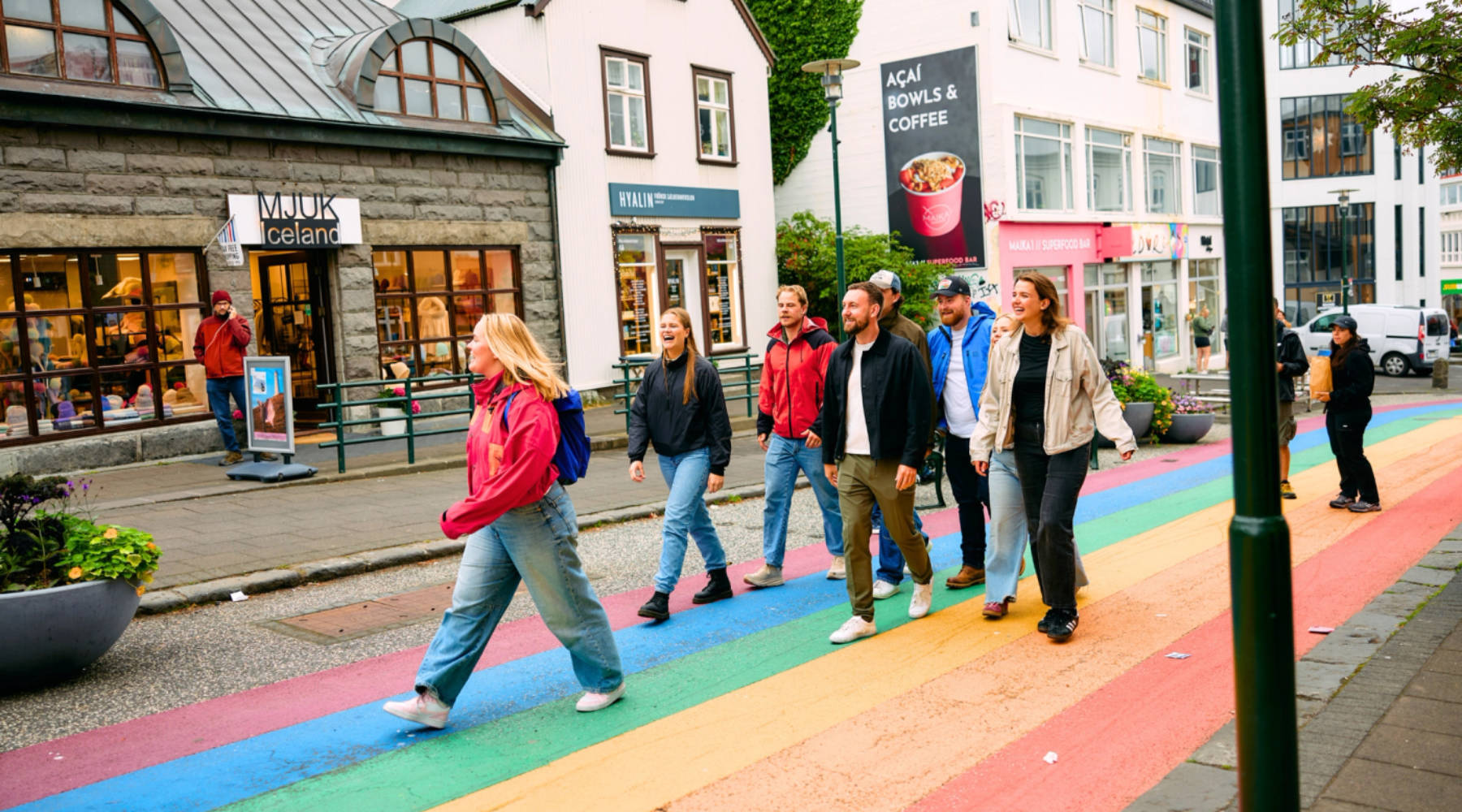 Eine Gruppe von Menschen geht durch die farbenfrohen Straßen von Reykjavik.