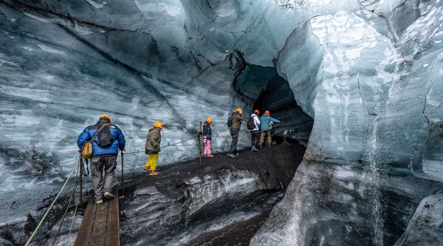 Group of tourists in an ice cave in Iceland.