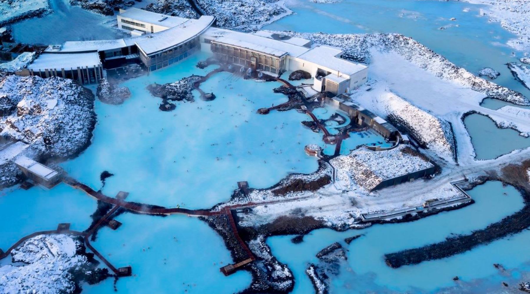 Aerial view of the Blue Lagoon surrounded by snow-covered lava fields in Iceland