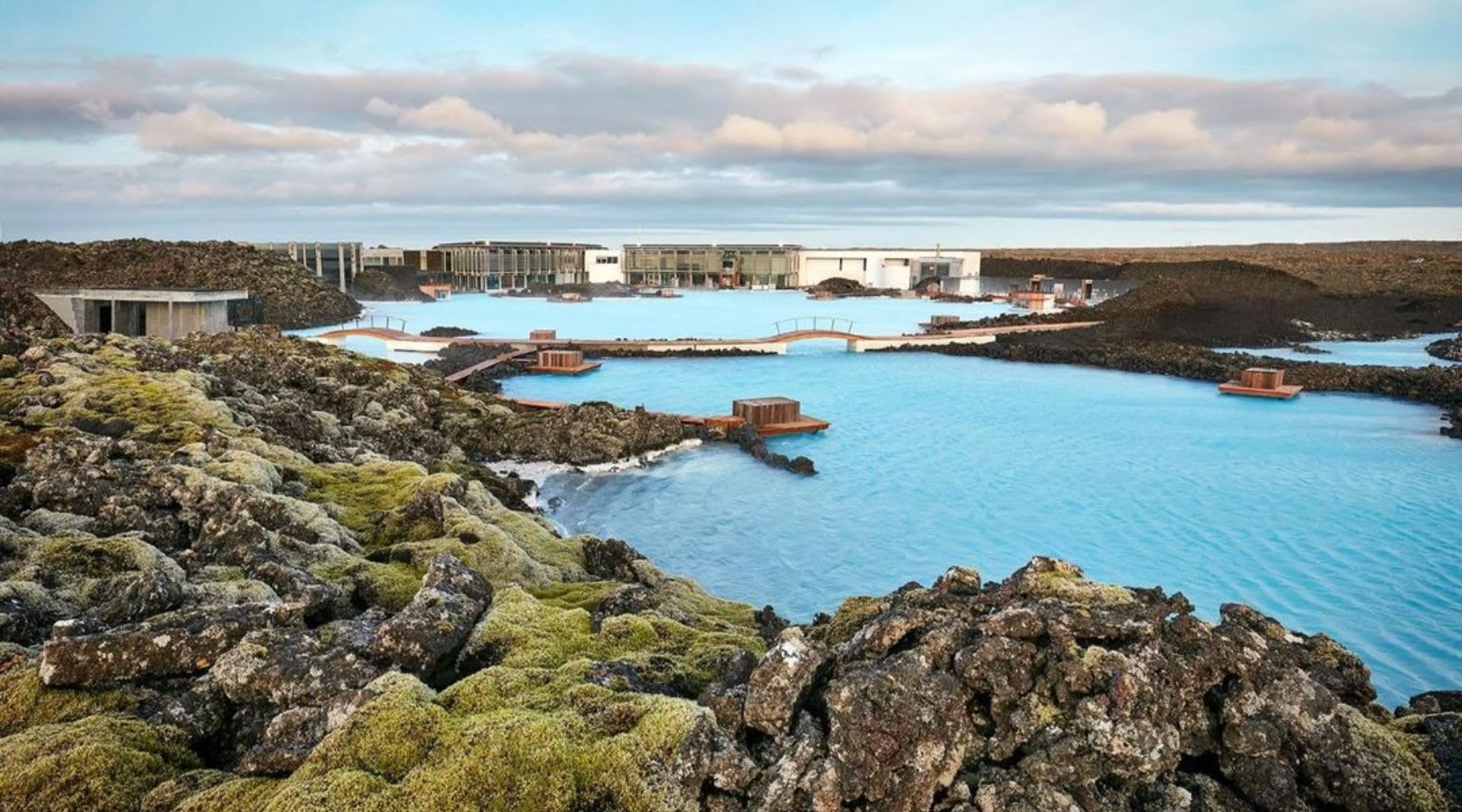 Blue Lagoon geothermal spa surrounded by mossy lava rocks in Iceland