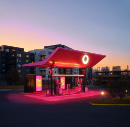 Illuminated gas station with red canopy at dusk in Iceland