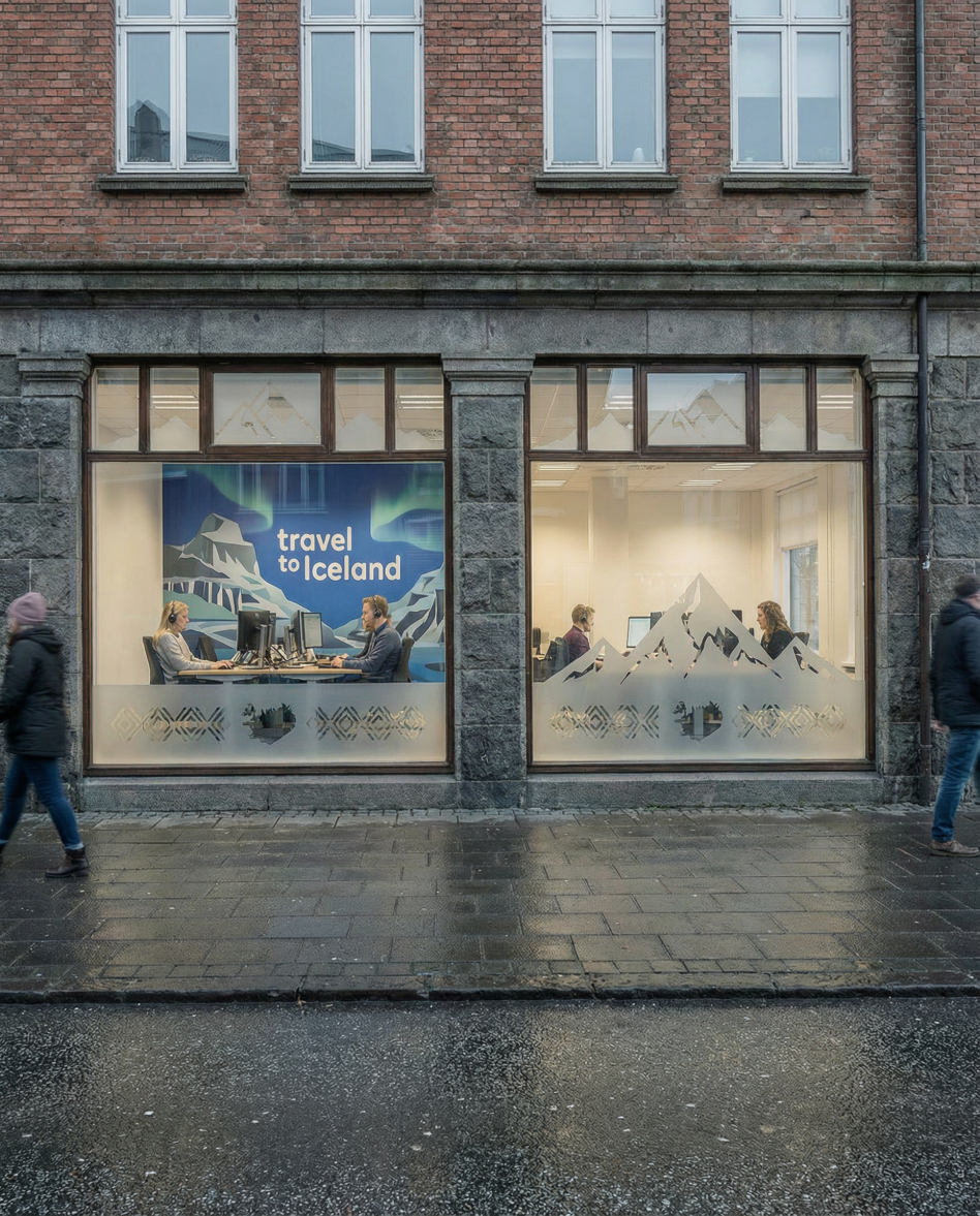 Gadebillede af Travel to Iceland-kontorets facade med folk, der går forbi på en regnvejrsdag