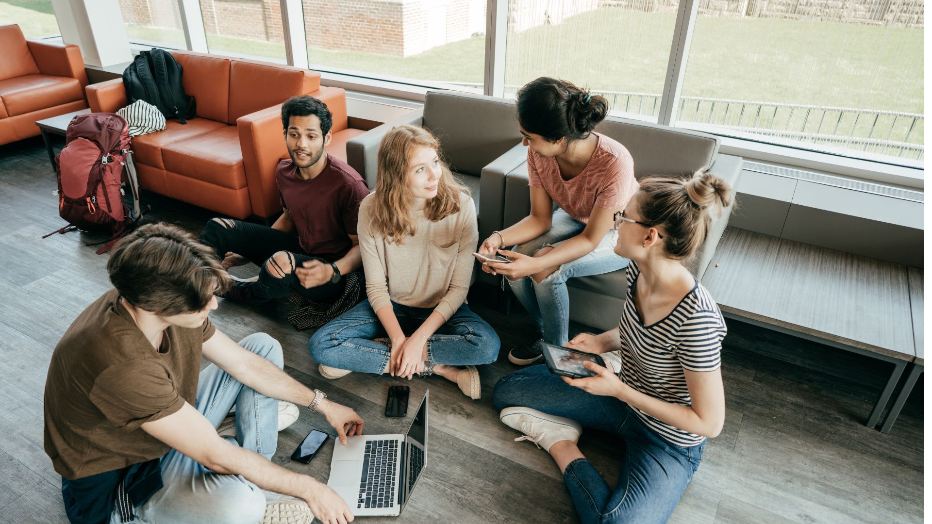 A group of people sitting on the floor working collaboratively together