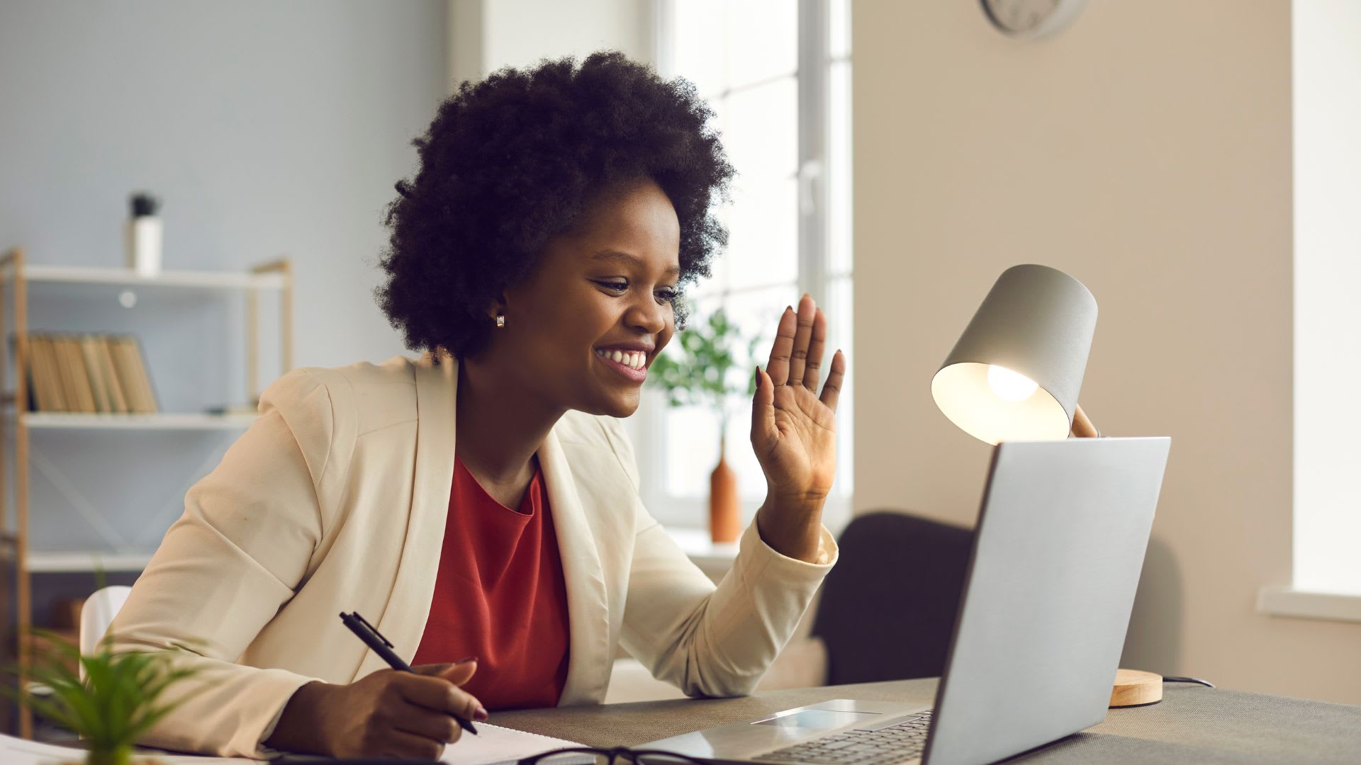 A remote employee engaged in a video conference from a home office, exemplifying successful adaptation to remote work environments.