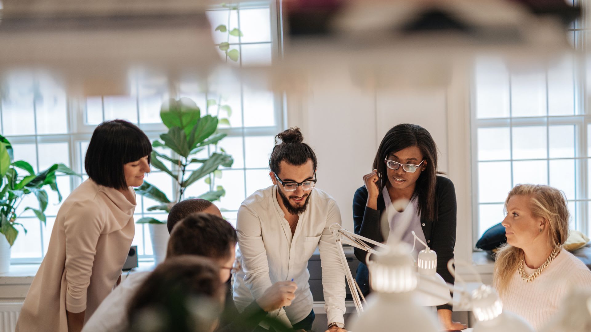 A diverse team actively engaged in a brainstorming session, symbolizing collaborative innovation and inclusive problem-solving.