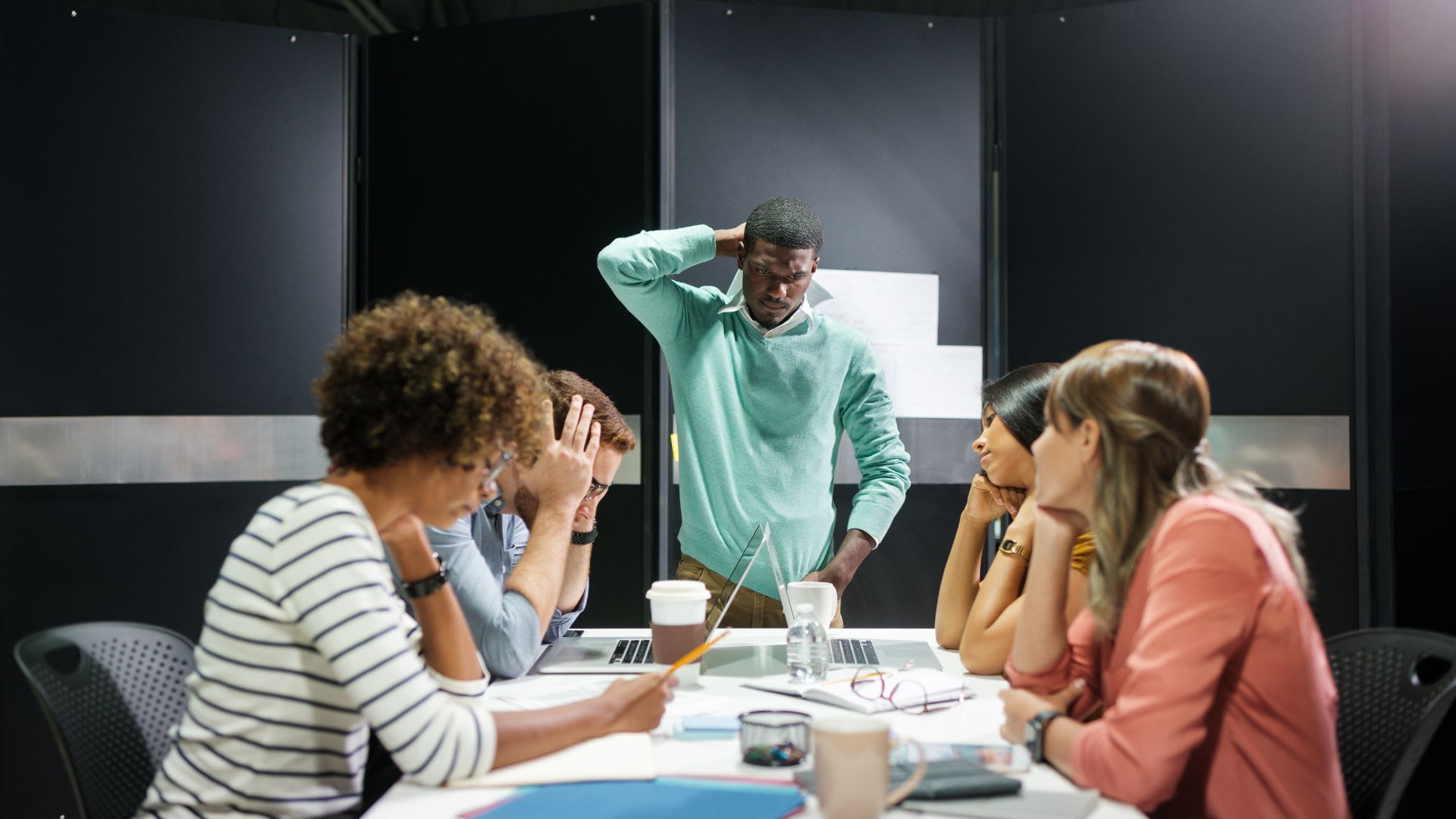 A team struggling with miscommunication, depicting the challenges of unclear workplace interactions.