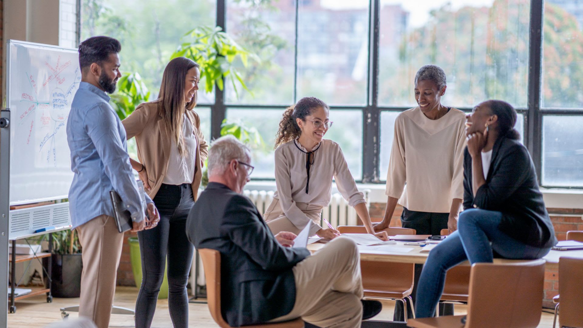 Office colleagues brainstorming together in a meeting room.