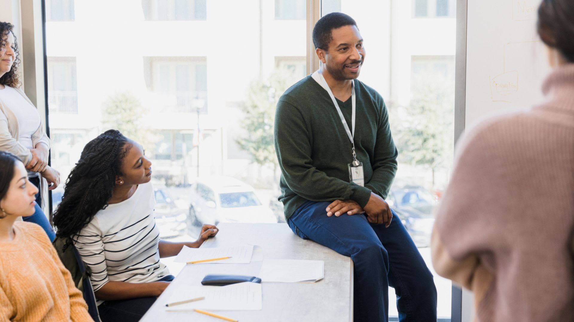 A diverse team of professionals discussing ideas and collaborating at a conference table in an office setting.