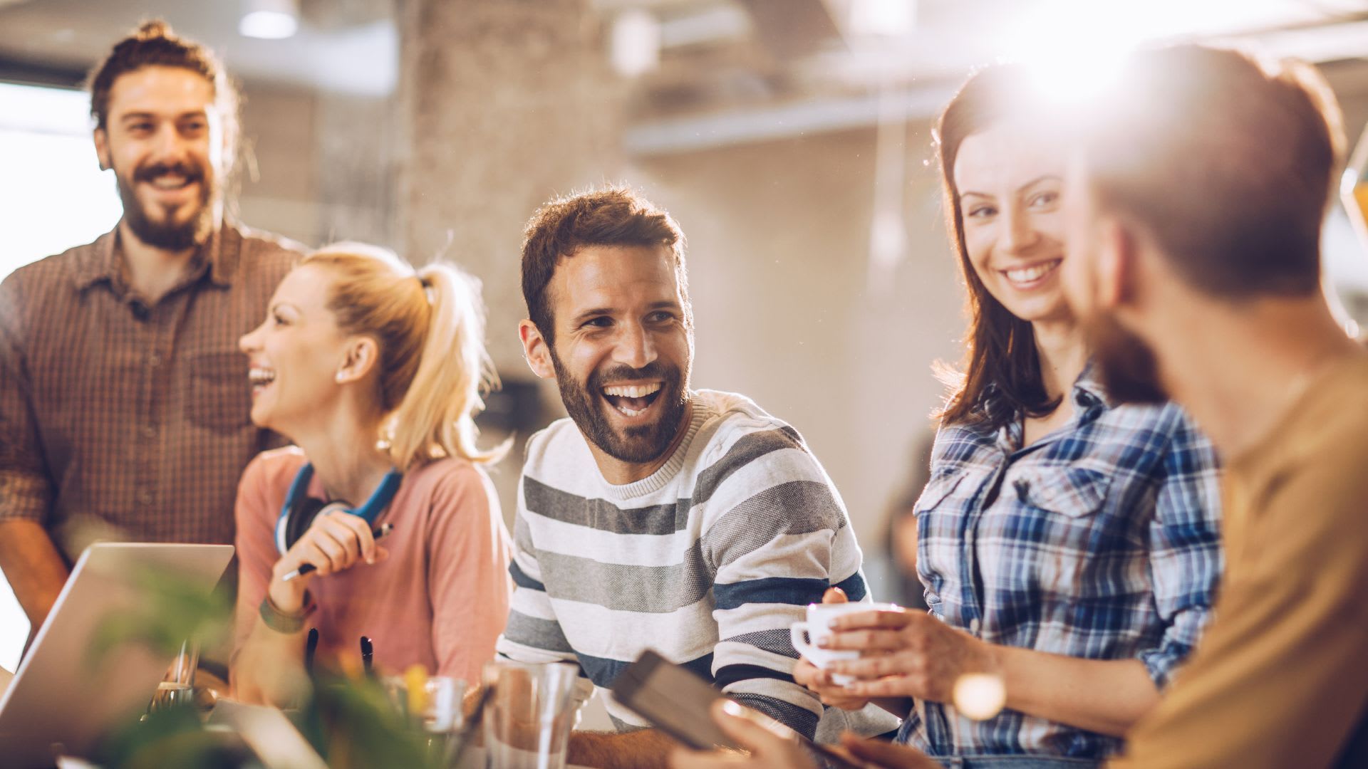 A joyful group of people sharing laughter and smiles, creating a warm and friendly atmosphere.