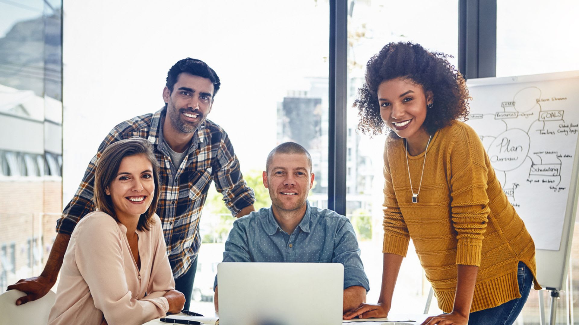 Portrait of a team of designers having a meeting in an office.