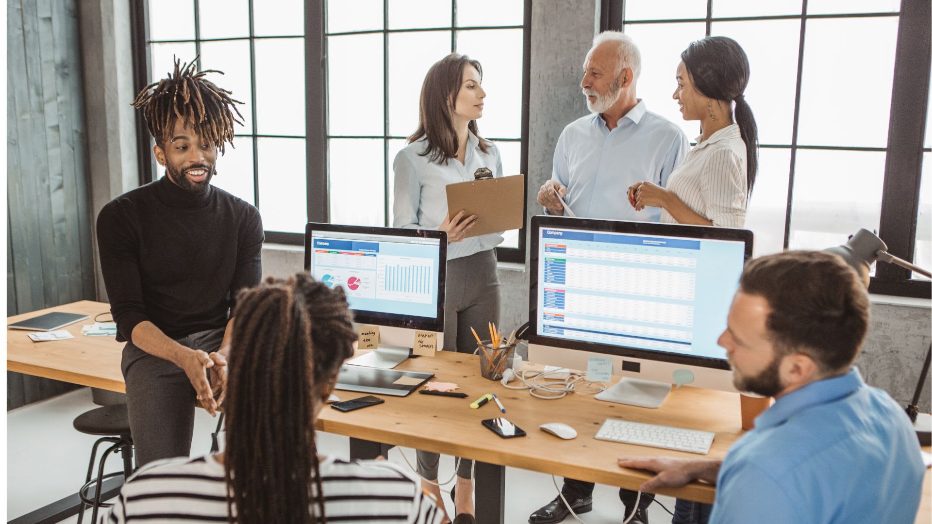 A group of professionals engaged in discussion within an office environment, collaborating on a project or idea.