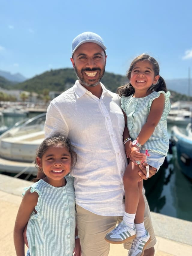 Adil Lalani smiling with his two children