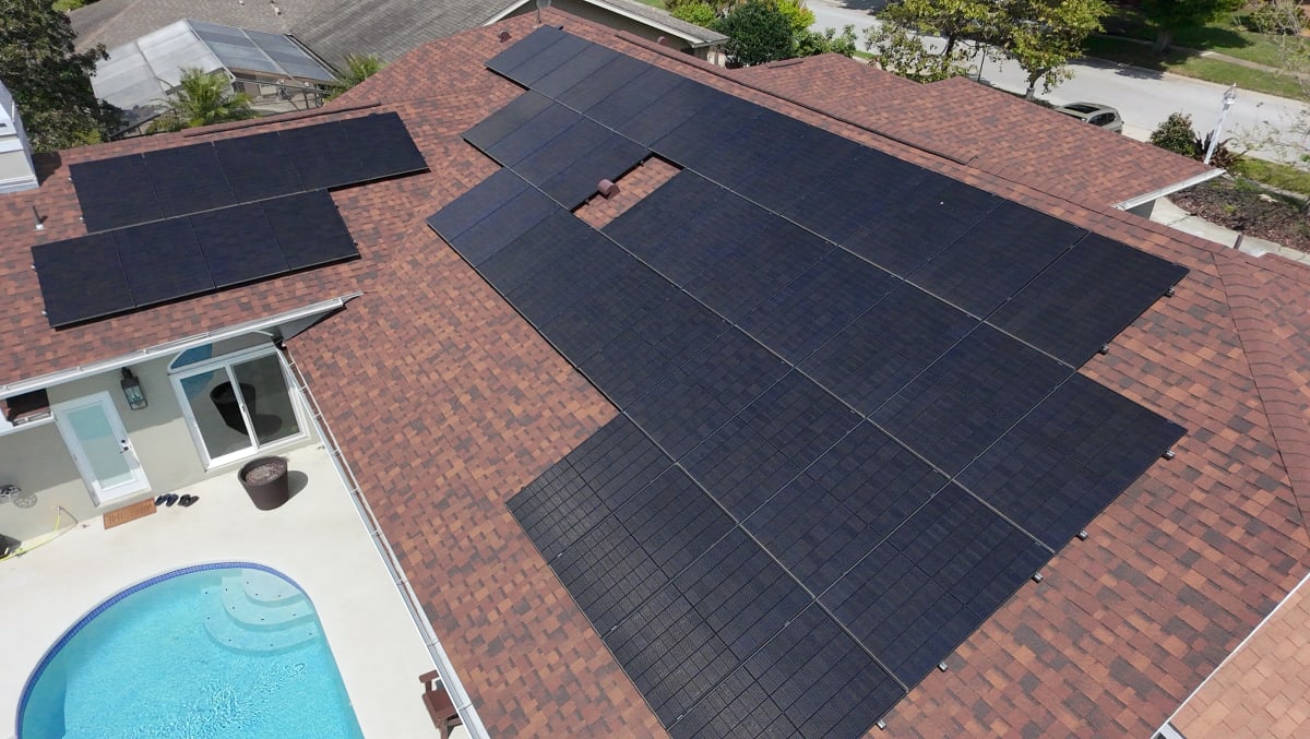 Completed solar installation on Florida home with pool — aerial view