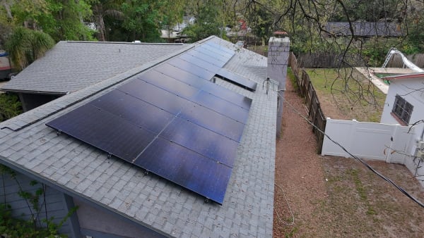 Completed rooftop solar system on gray shingle home