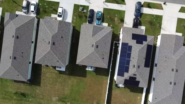 Aerial neighborhood view showing completed solar installation
