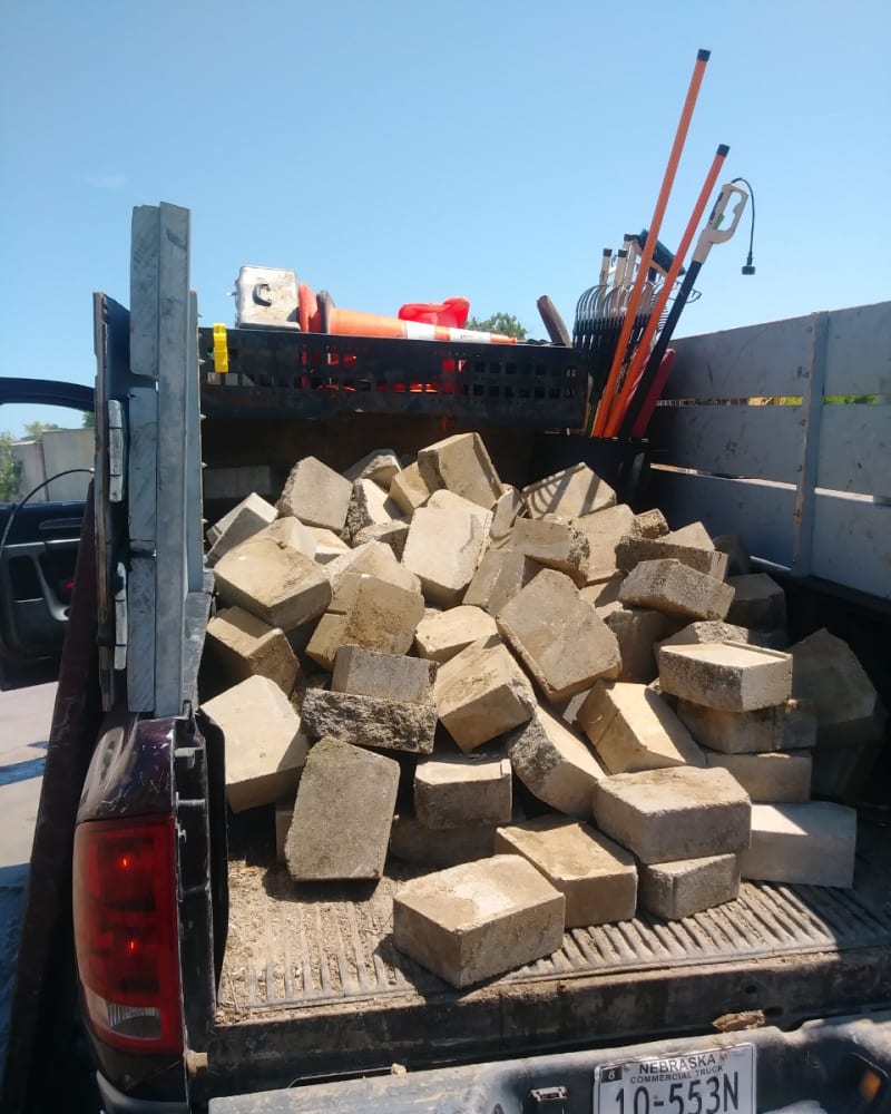 Truck bed loaded with concrete blocks and pavers after removal by A1 Junk Removal and Tree Service in Omaha, NE