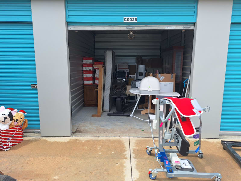 Storage unit packed with mattress, furniture, boxes, and equipment before cleanout by A1 Junk Removal in Omaha, NE