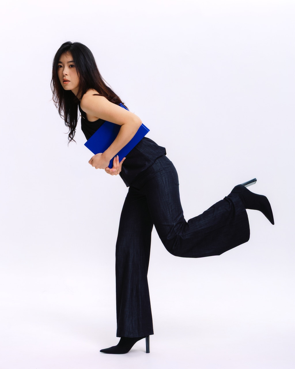 Full-length lookbook fashion portrait with a cobalt blue accessory