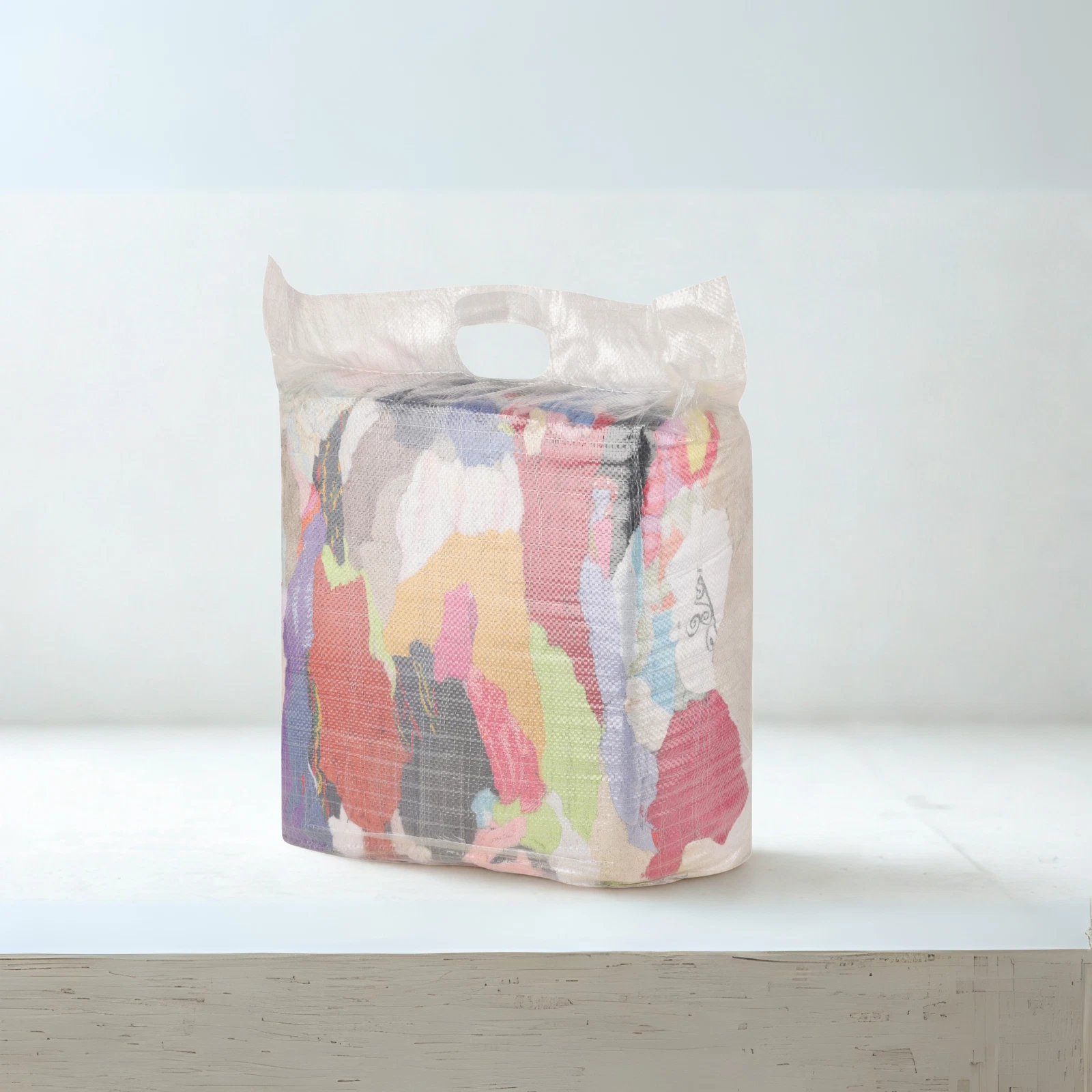 Pile of loose cleaning rags showing variety of sizes and colours for industrial use.