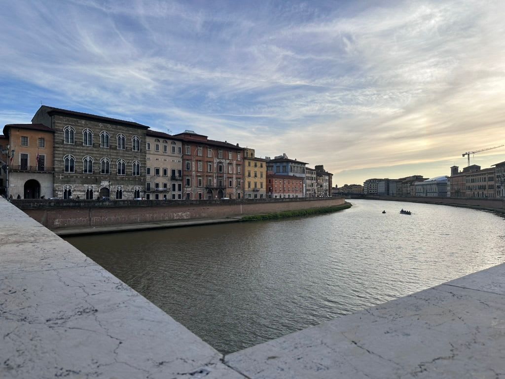 The Arno riverfront in Pisa at dusk