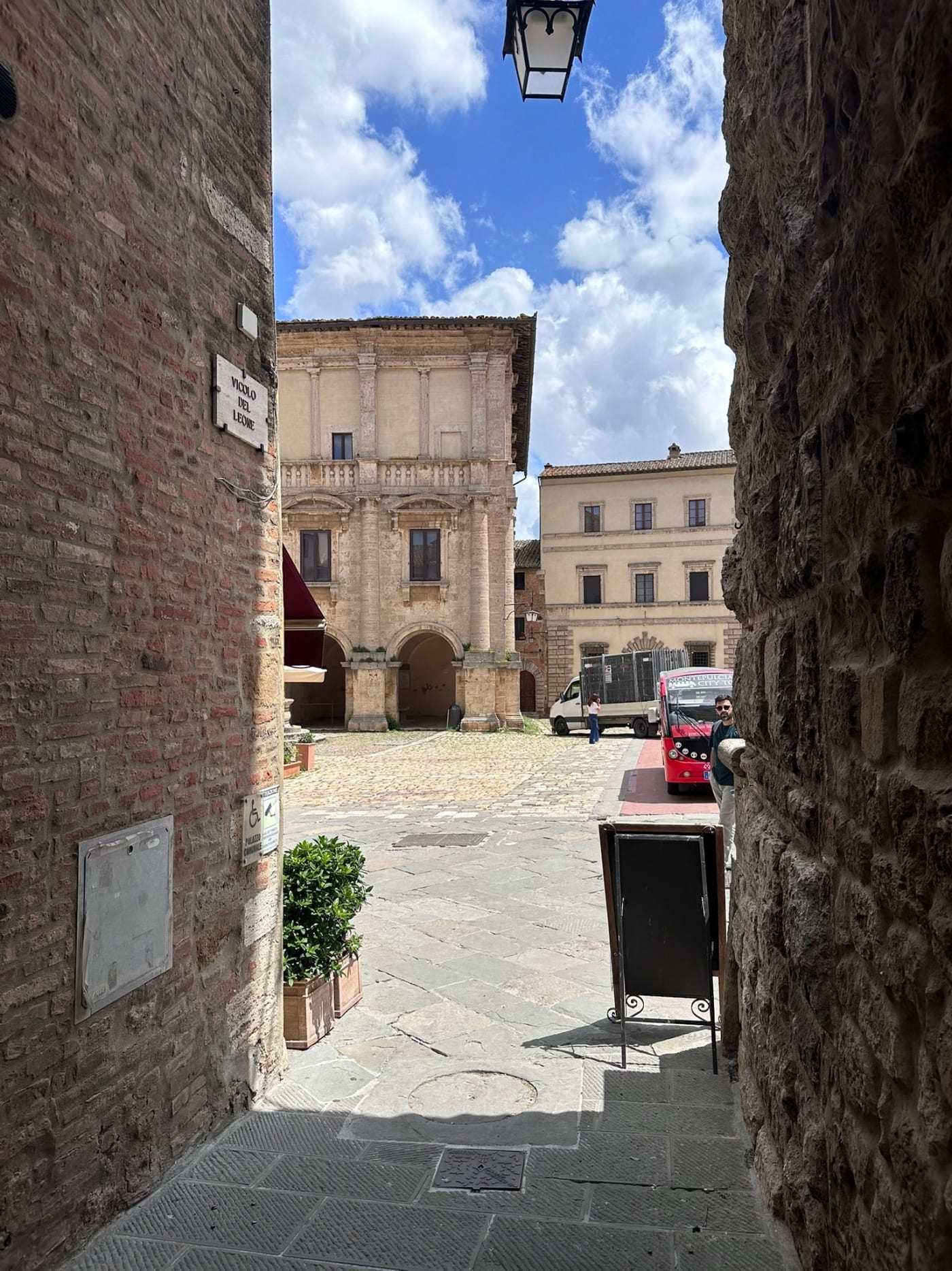 A stone archway opening onto a piazza in Montepulciano