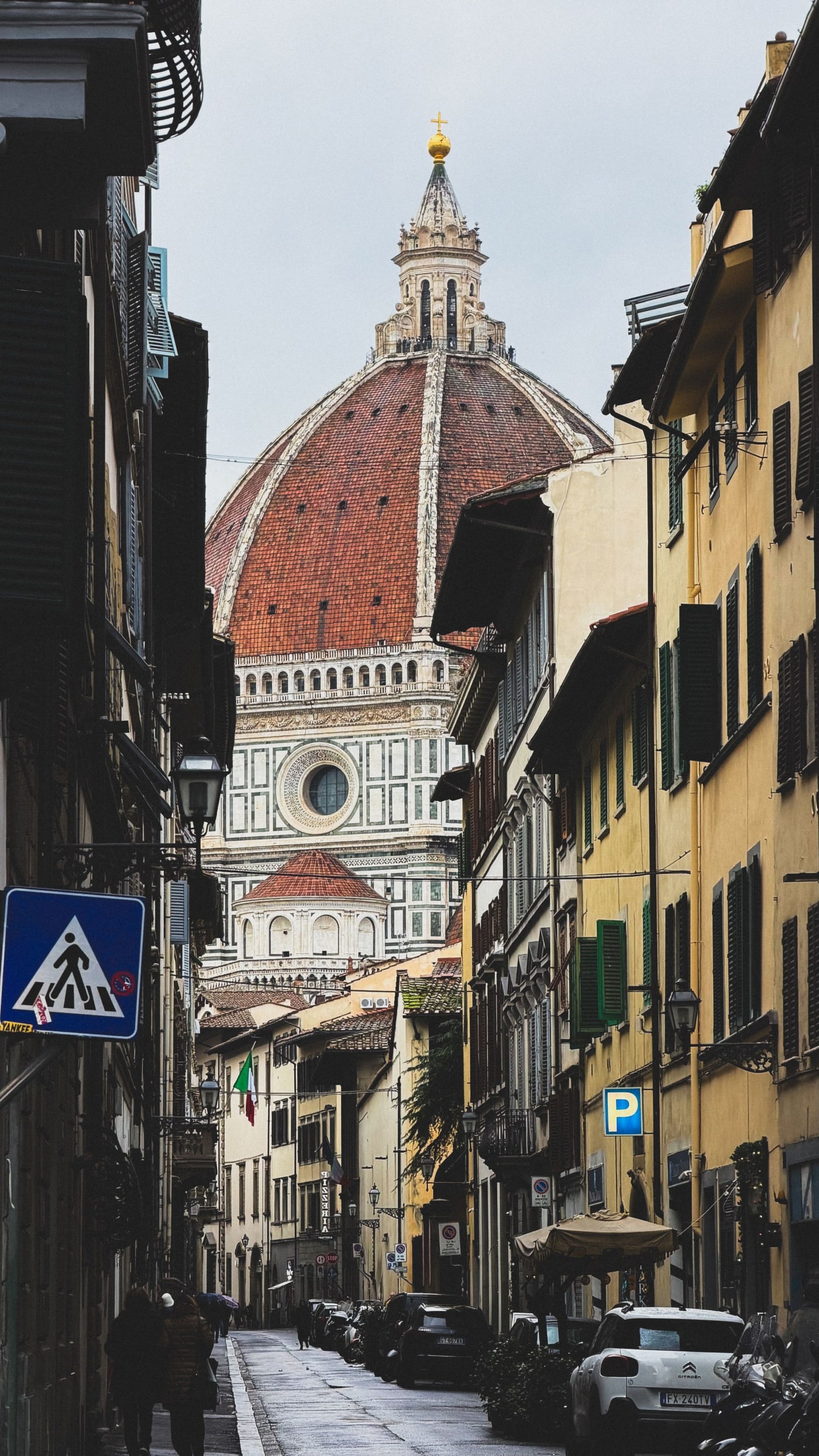Brunelleschi's dome of Florence cathedral seen down a narrow street