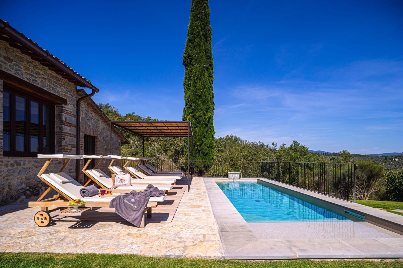 Casa Faraonia — the saltwater pool beside a tall cypress