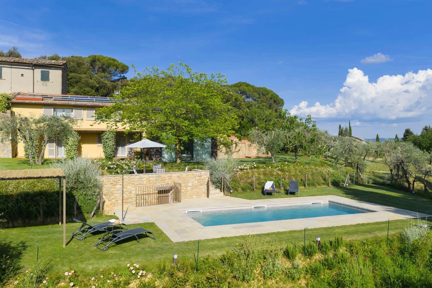 Casa Lilia — the pool and lawn in the sun