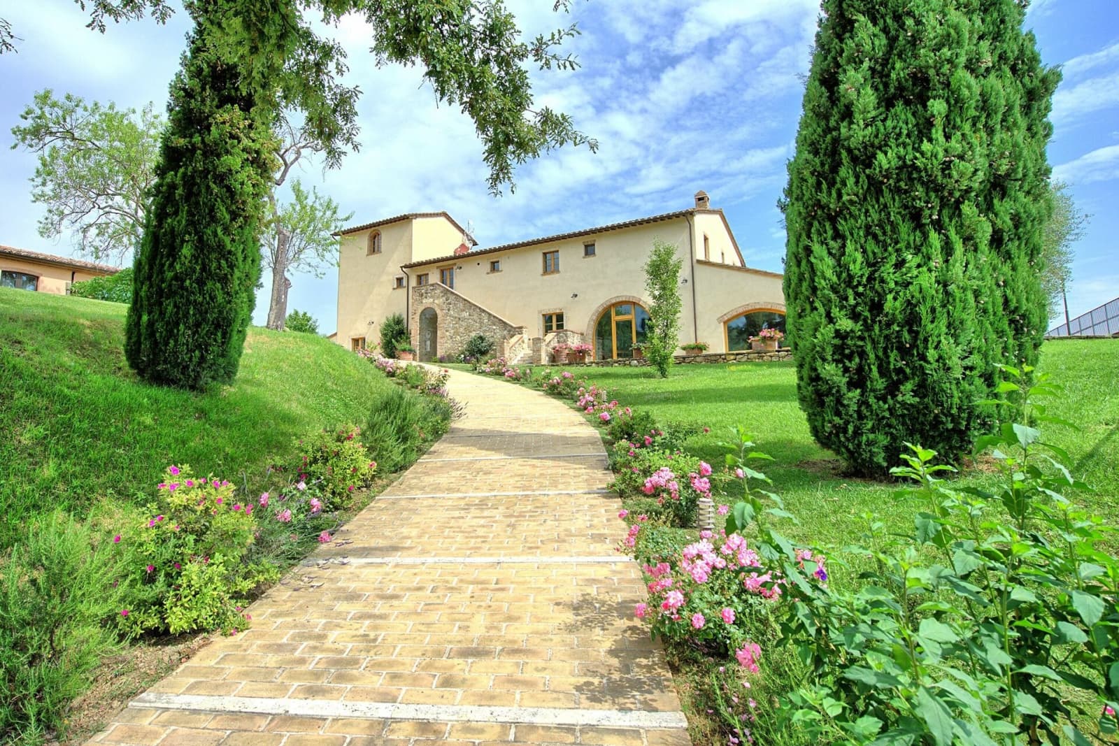 Tenuta La Barricaia — the garden path up to the stone villa, lined with cypresses