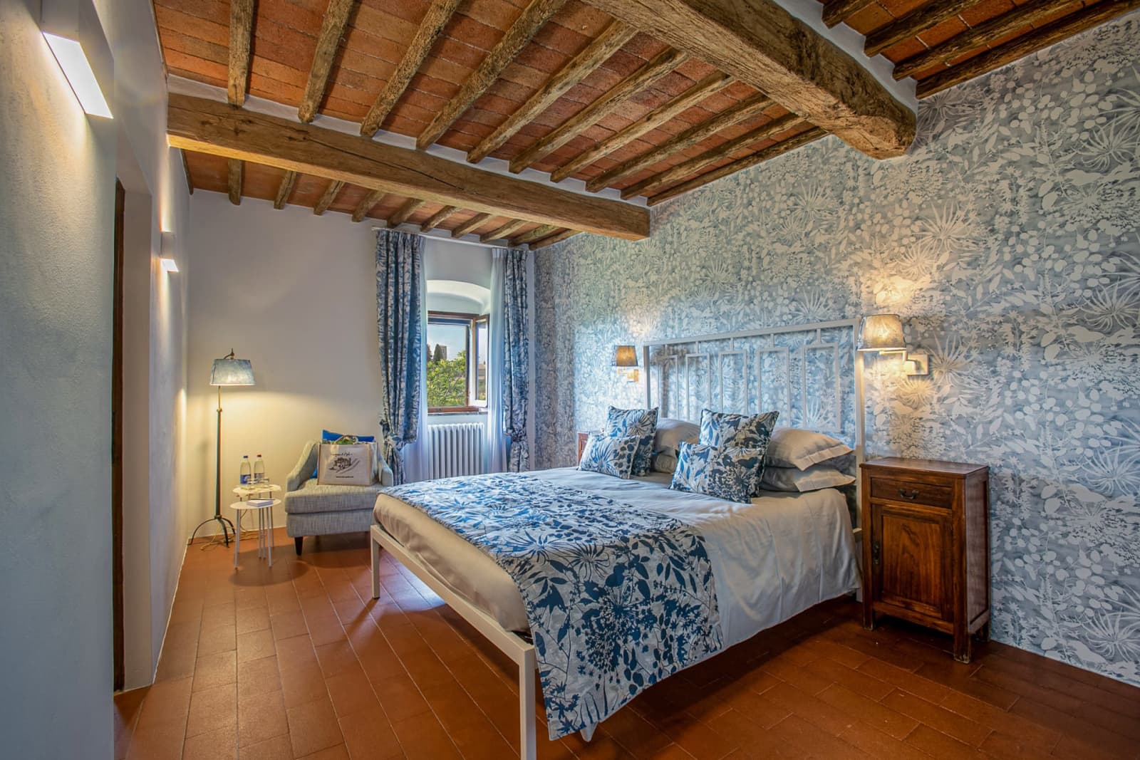 Casa dell'Erta — a bedroom with blue linen beneath the beams