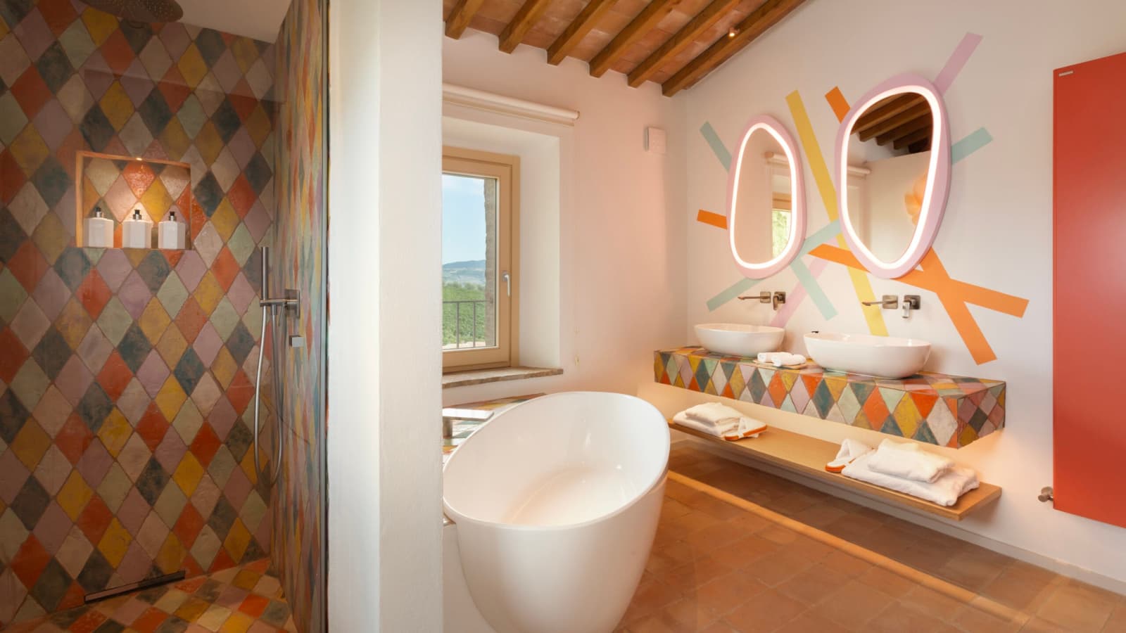 Podere Mastrojanni — a bathroom with harlequin tile and a double vanity