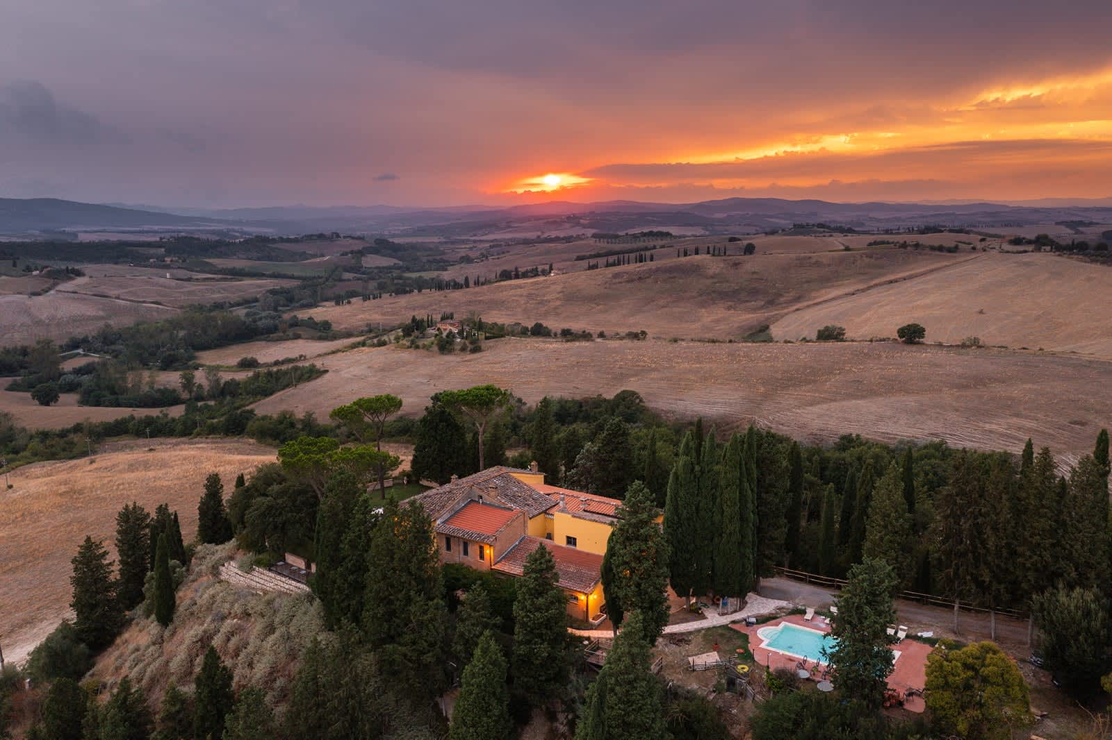 Villa Poggio d'Oro — the villa, park and pool at sunset, from above