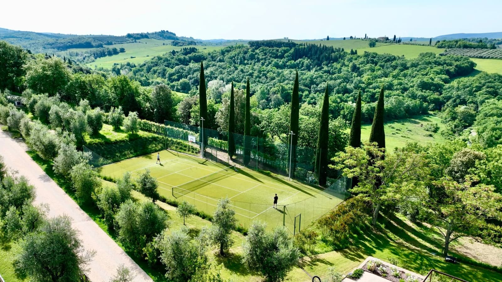 Tenuta Belvedere Estate: Tenuta Belvedere — the tennis court among the cypresses
