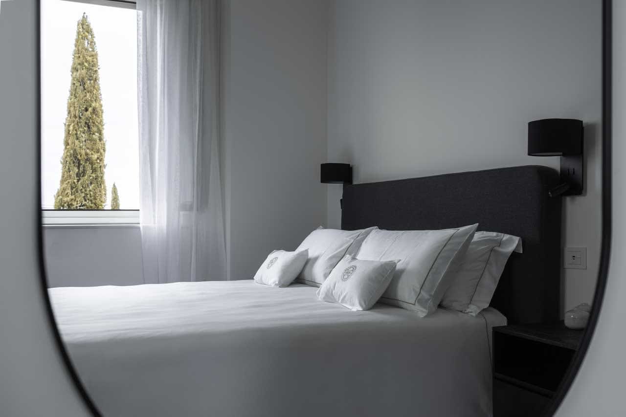 Tenuta Belvedere Estate: Tenuta Belvedere — a villa bedroom in white