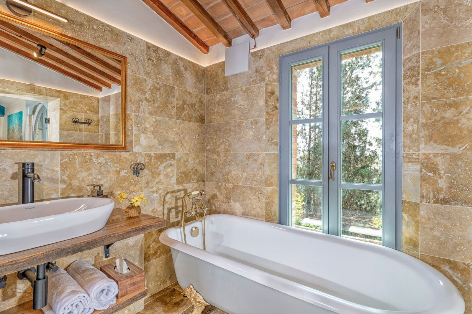 Villa Poggio d'Oro — a stone-walled bathroom with a freestanding tub