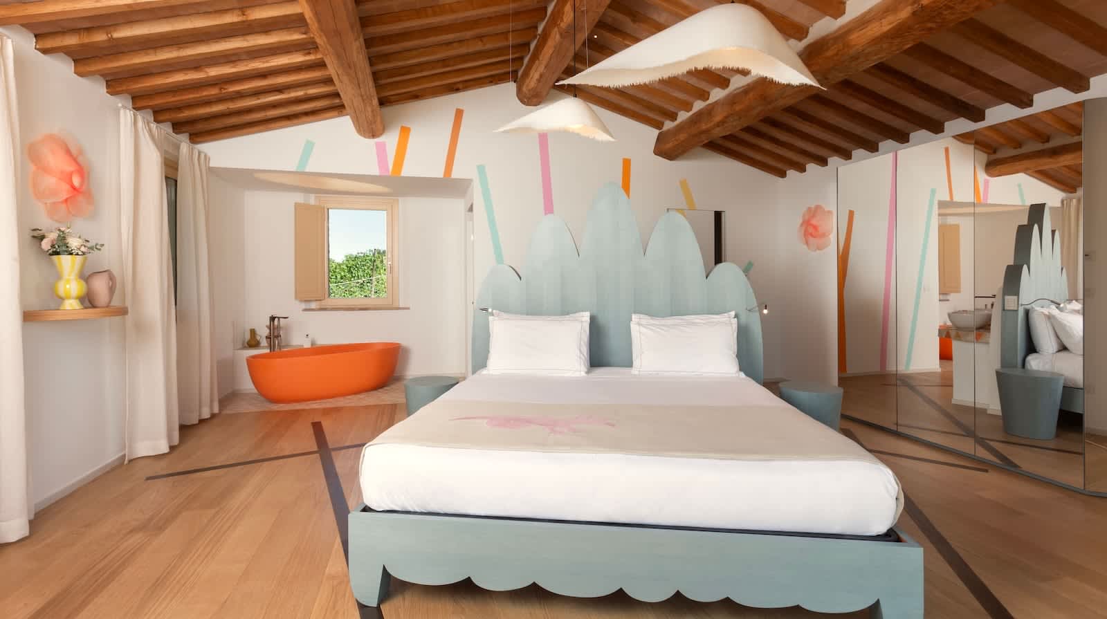 Podere Mastrojanni — the dependance's main bedroom, with an in-room tub