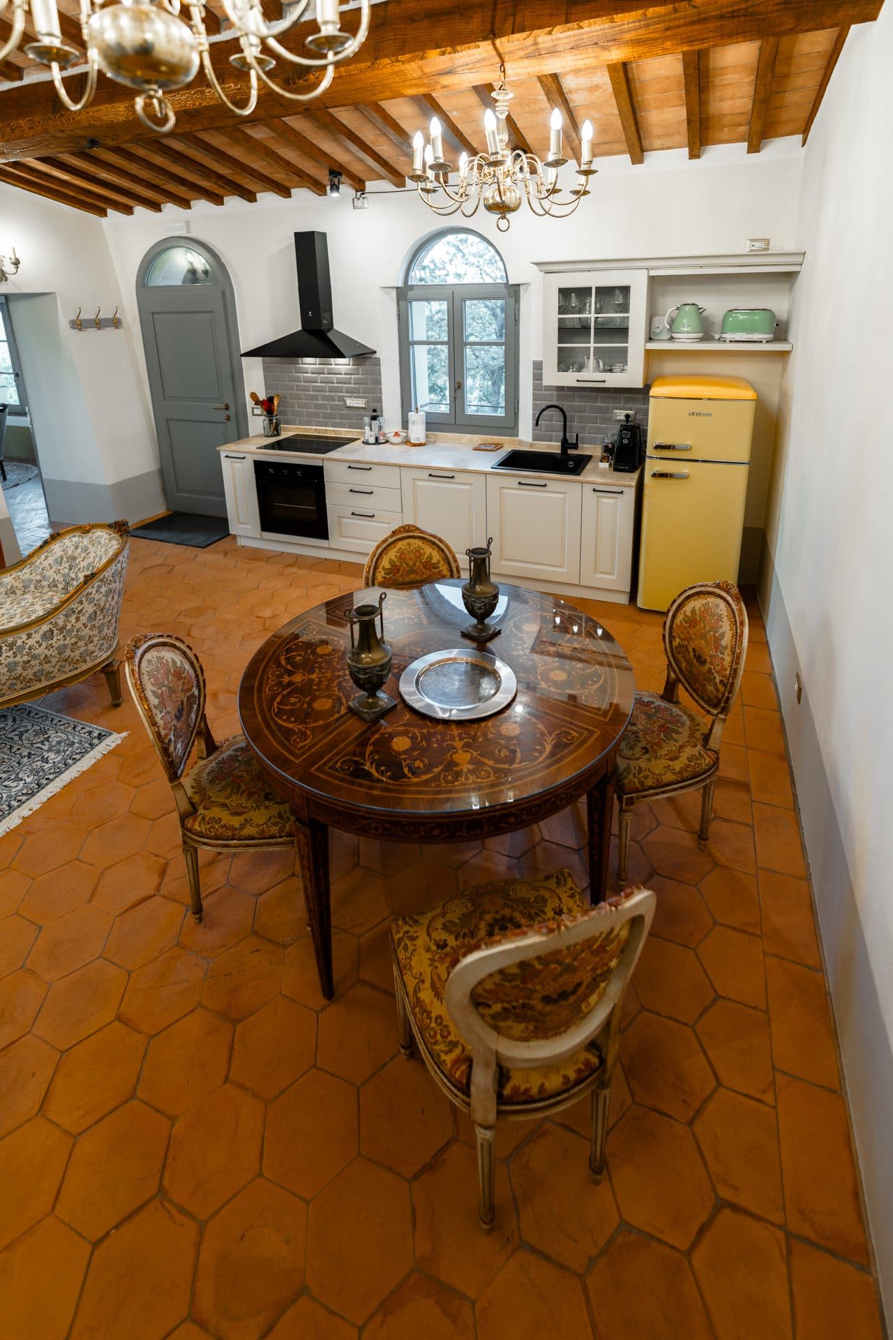 Villa Poggio d'Oro — a kitchen and dining table with a butter-yellow fridge