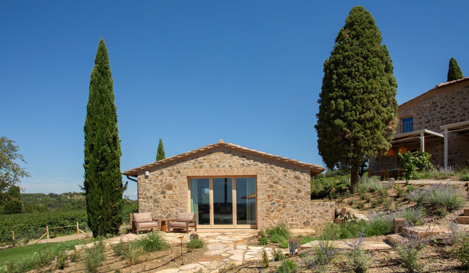 Podere Mastrojanni — the dependance exterior among the cypresses