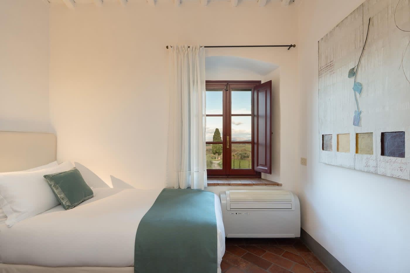 Villa Castellaro — a bedroom with a window over the garden