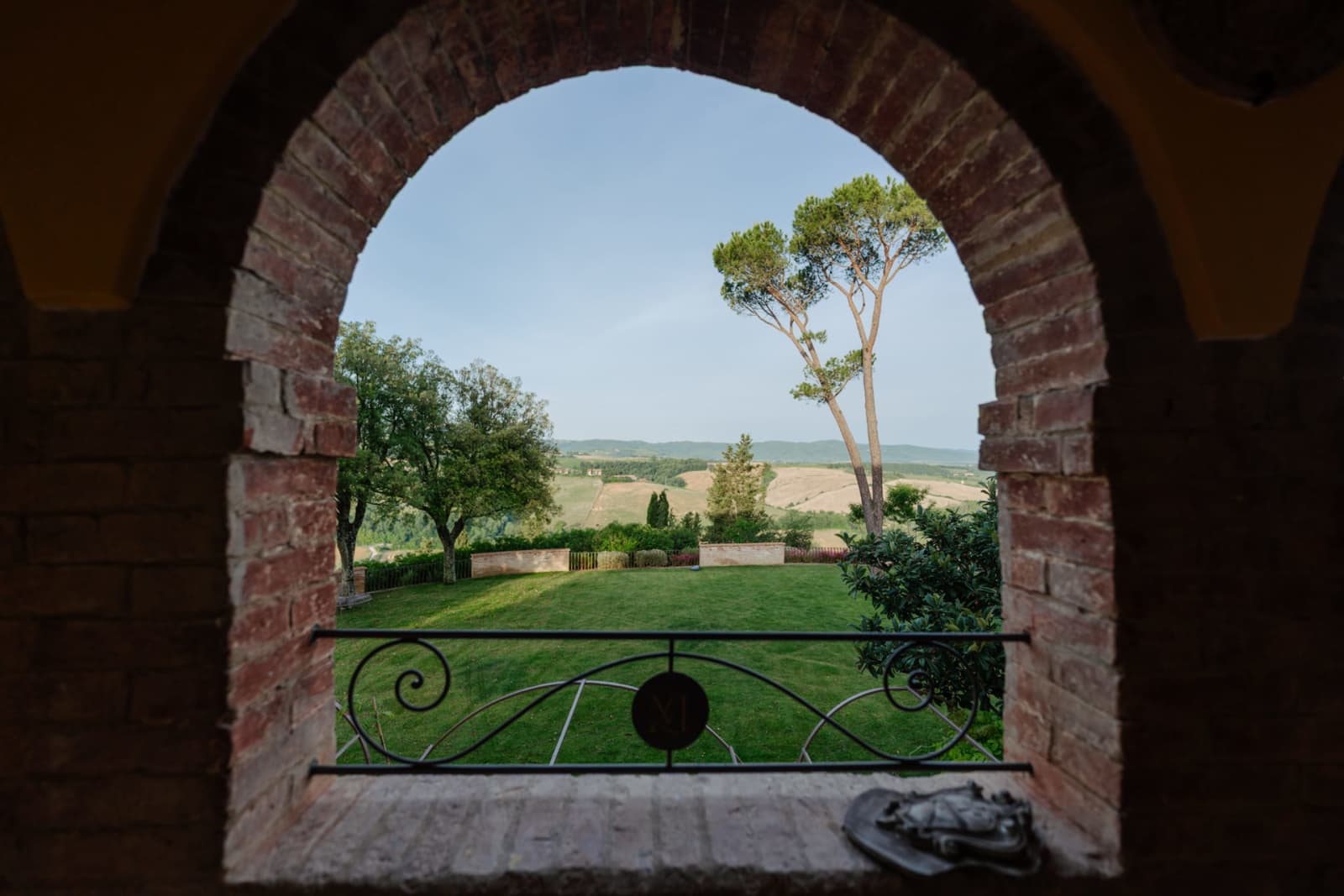 Villa Poggio d'Oro — the park seen through a brick archway