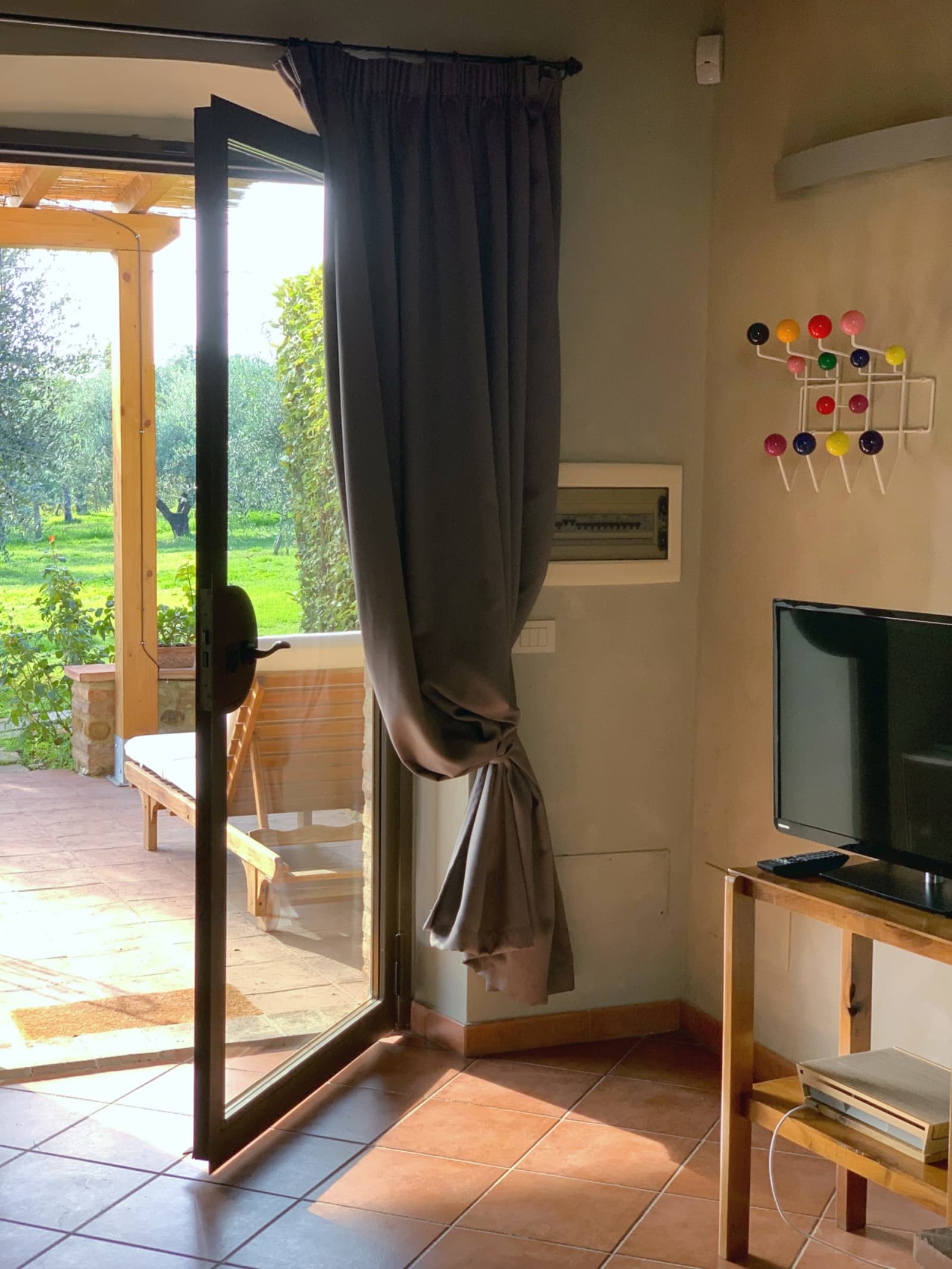 Casale Olivaio — a bedroom with linen curtains