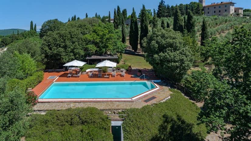 Borgo delle Vigne — an aerial view of the pool, framed by cypress and olive trees