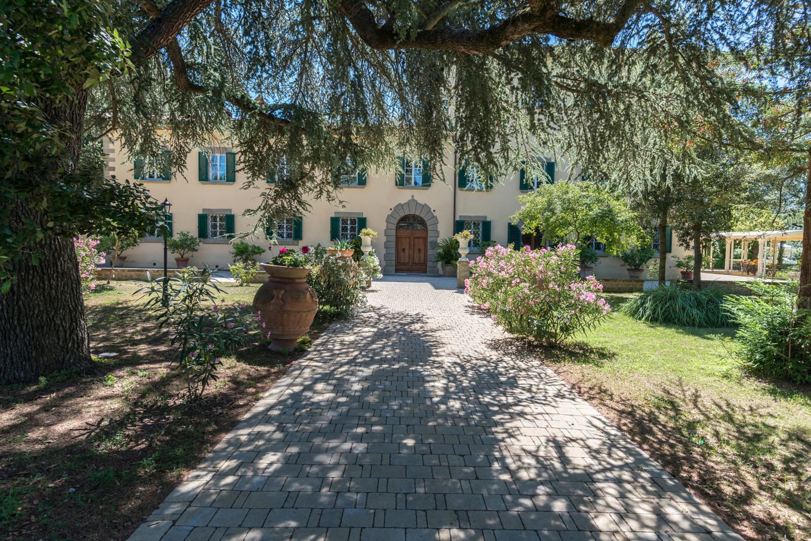 Villa della Cappella — tree-lined approach to the front door