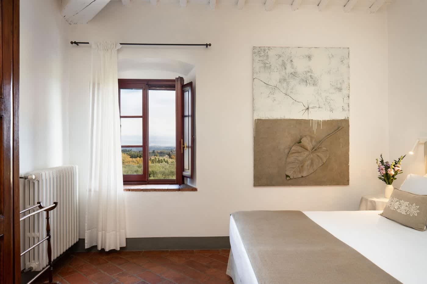 Villa Castellaro — a bedroom with a window onto the countryside