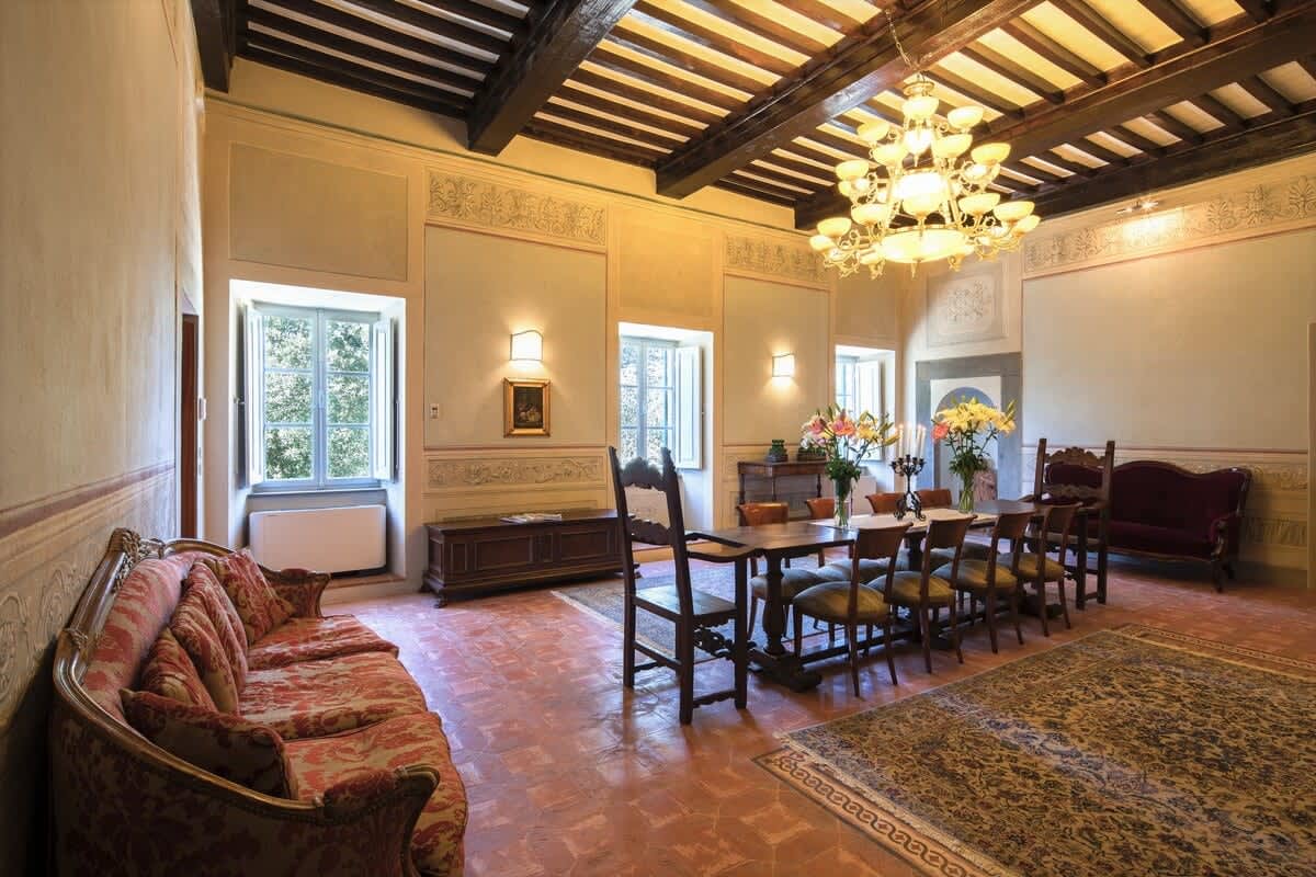 Villa della Cappella — the frescoed, beamed dining room set for dinner